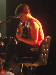 kakki king playing her guitar