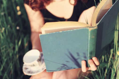 girl reading with cup of tea