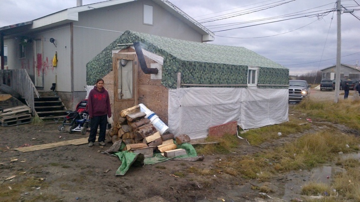 a mother stands in the tent she has shared with her husband and 4 children for 2 years via huffingtonpost.com