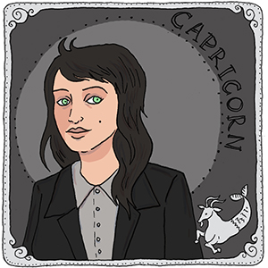 illustration of a white woman with long dark hair and green eyes, representing the sign capricorn