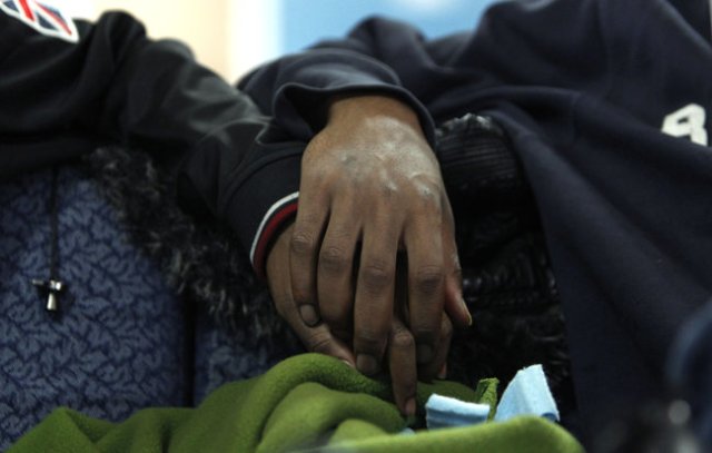 Two boys hold hands at the Ruth Ellis Center in Detroit, the only nonprofit agency in the Midwest that focuses on LGBT youths. It has 10 beds.  AP Photo by Paul Sancy, 2012.