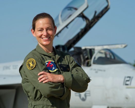 Nicole Aunapu Mann stands in front of an F-18, the twin-engine supersonic, all-weather carrier-capable multirole fighter jet she piloted for the Marines. Via PopSci.