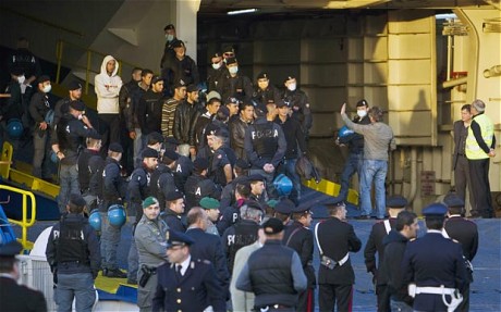 Tunisian refugees disembark at the port of Civitavecchia, near Rome via The Telegraph