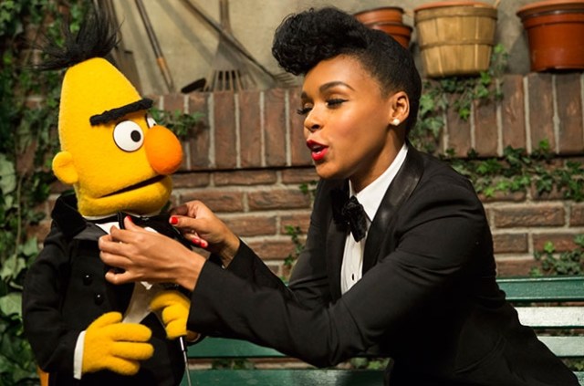 Janelle Monáe teaches Bert how to tie a bowtie.