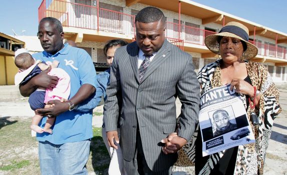 "John Cooks, the uncle of Crystal Jackson, left, Victoria Rubio, partially obscured, Quanell X and Patricia Nixon, the grandmother of Britney Cosby, attend a prayer vigil for the two slain young women." via houston chronicle