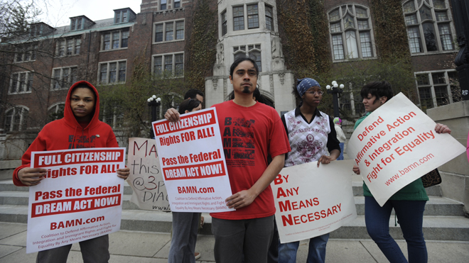 Jose Alvarenga, center, BAMN (By Any Means Necessary) national organizer, and others protest the Supreme Court ruling on the campus of the University of Michigan Tuesday, April 22, 2014, in Ann Arbor, Mich. The justices ruled 6-2 that Michigan voters had the right to change their state constitution in 2006 to prohibit public colleges and universities from taking account of race in admissions decisions. (AP Photo/Detroit News, David Coates ) DETROIT FREE PRESS OUT; HUFFINGTON POST OUT.