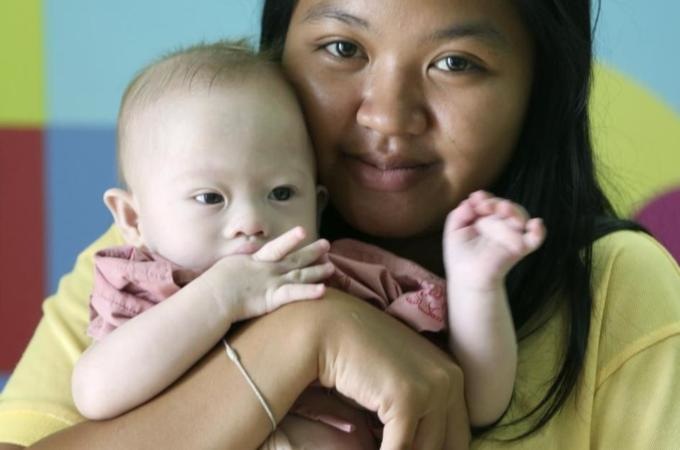 21-year old mother Pattaramon Janbua holds baby Gammy, who she claims was abandoned by his intended parents. via Aljazeera