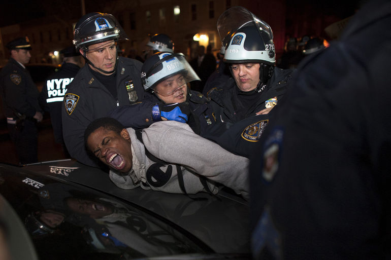 NYPD officers arrest a young man during a protest in the Brooklyn borough of New York