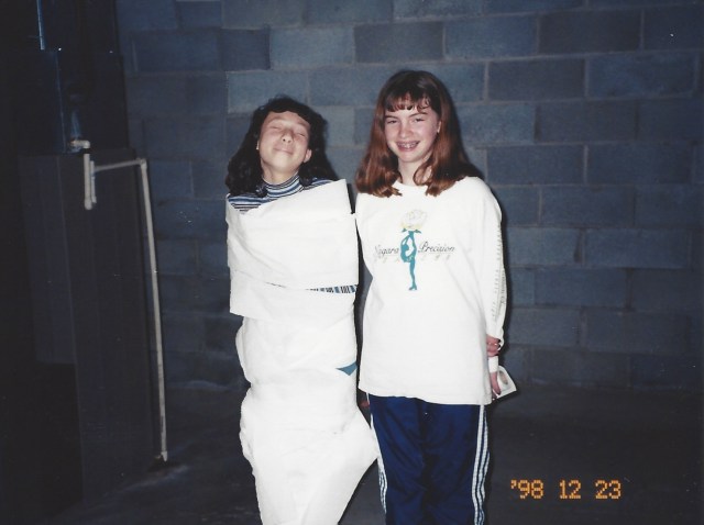 Laura and Kate playing the "mummy wrapping game" at Laura's 12th birthday party. Oswego, 1998.