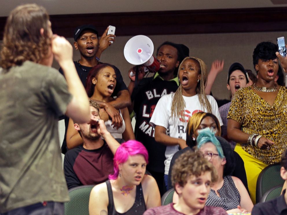 "Protesters shout during a news conference about the shooting death of Walter Scott at city hall in North Charleston, S.C., April 8, 2015." by Chuck Burton / AP Photos