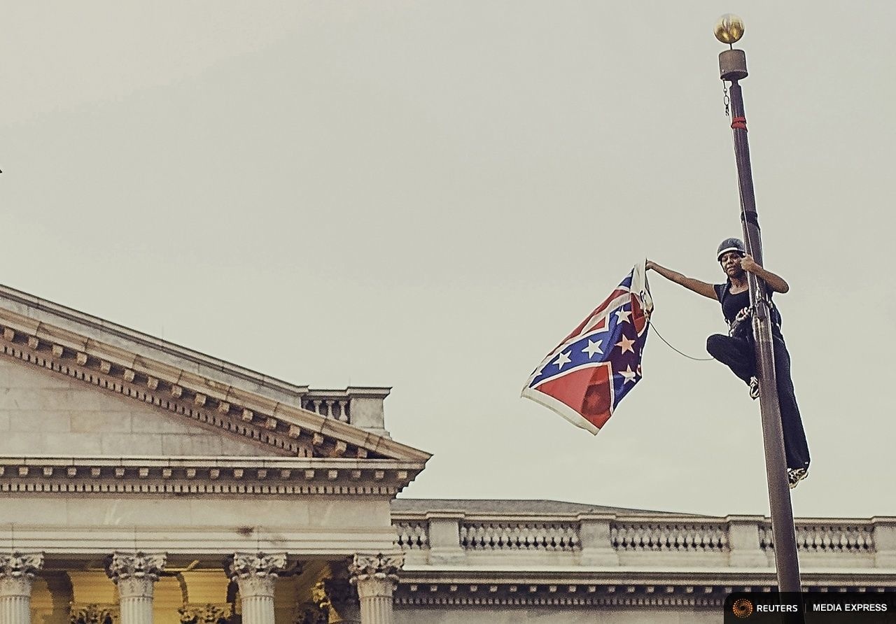 via Vox Bree Newsome triumphantly taking down the Confederate Flag