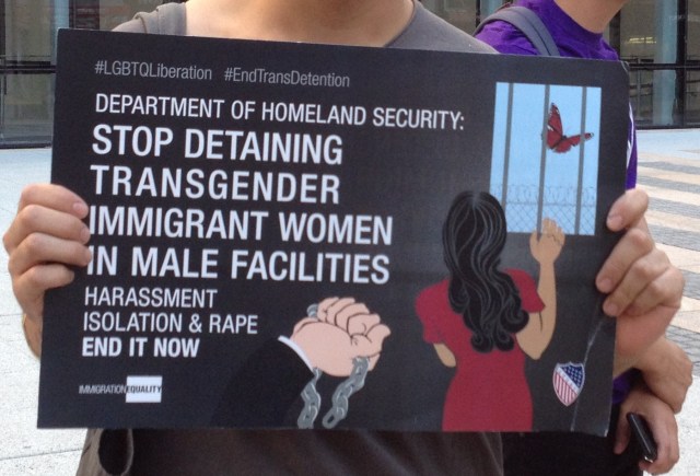 A protestor holds a sign outside ICE demanding an end to the detention of transgender immigrant women. photo by the author