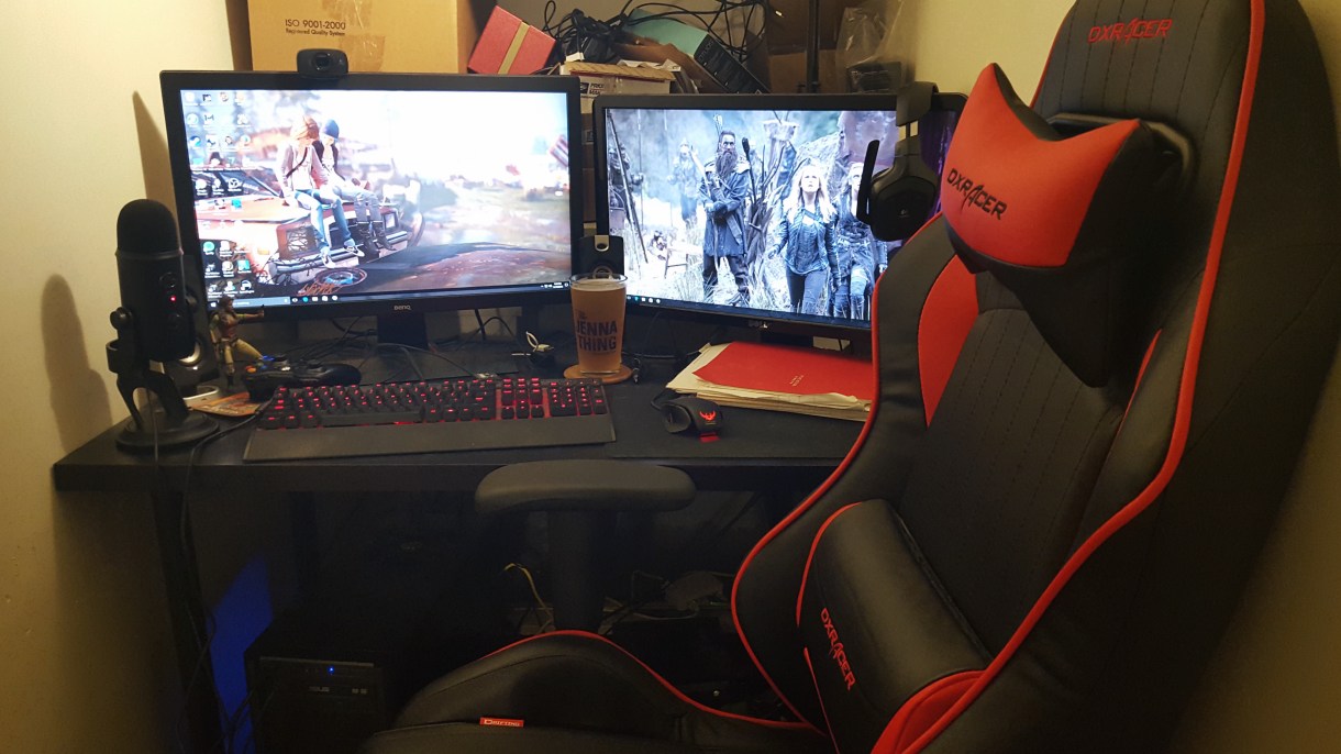 S Dufrau: Two monitors, webcam, speakers, mic, Zoe Washburne, coasters, Xbox controller, mechanical keyboard, too many cords, usb adapter, beer, pen, mouse, mousepad, notebook, headset, race-car chair, cat hair, tons of junk in the background because my office is an actual closet.