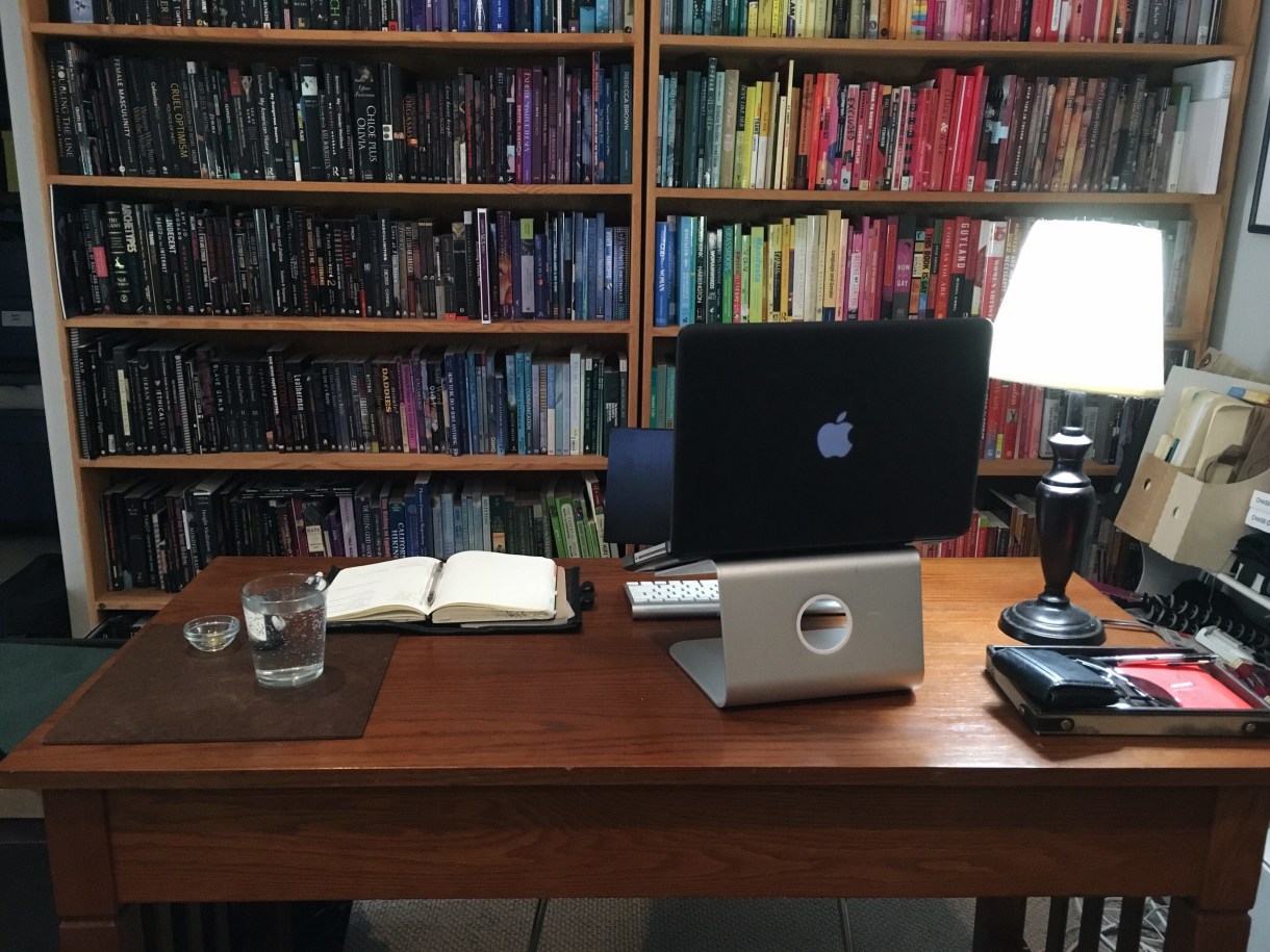 Sinclair: Macbook pro, apple wireless keyboard, rain design mStand, lamp; small leather box which holds sunglasses, keys, wallet, small pocket books, pen; journal/planner/bullet journal & pen, water, small dish of vitamins/meds.