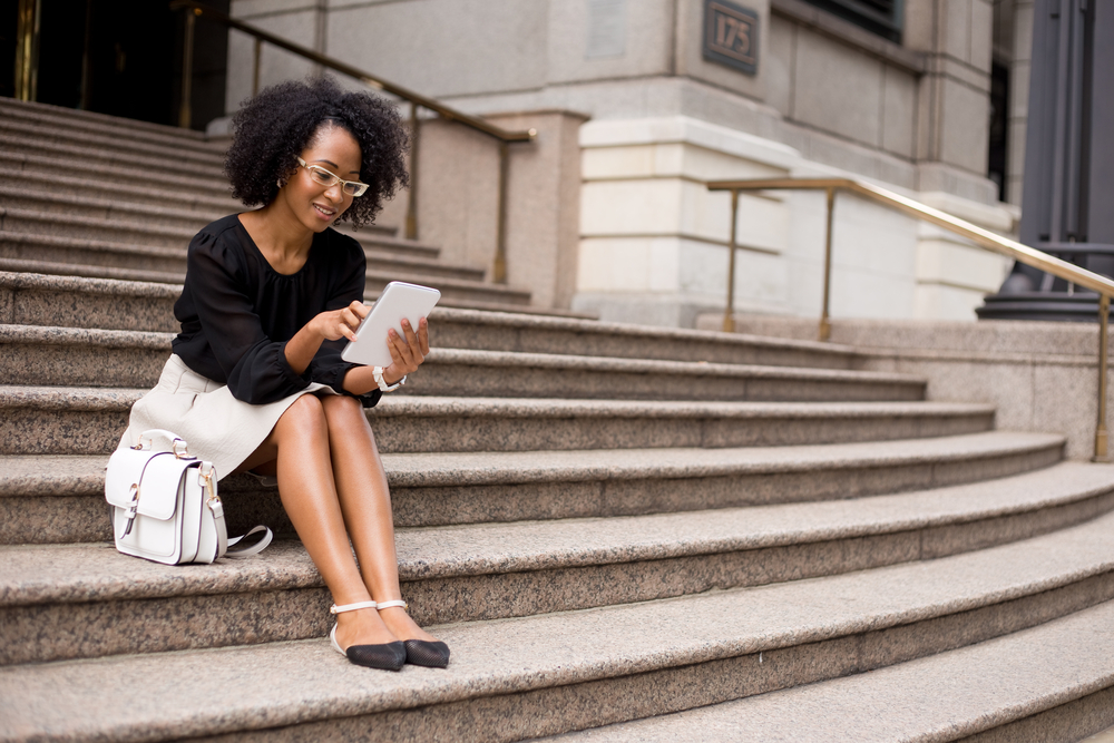 A woman reading on some stone steps