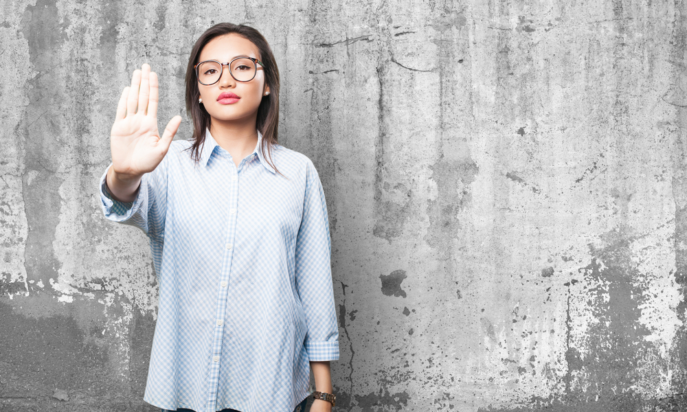 woman making a stop gesture toward the camera