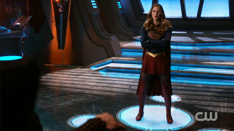 Supergirl stands with her arms crossed