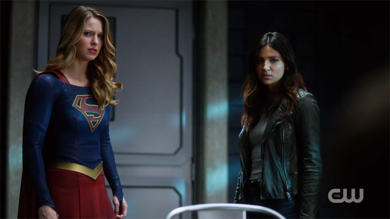 Supergirl and Maggie look worriedly back at Rick 