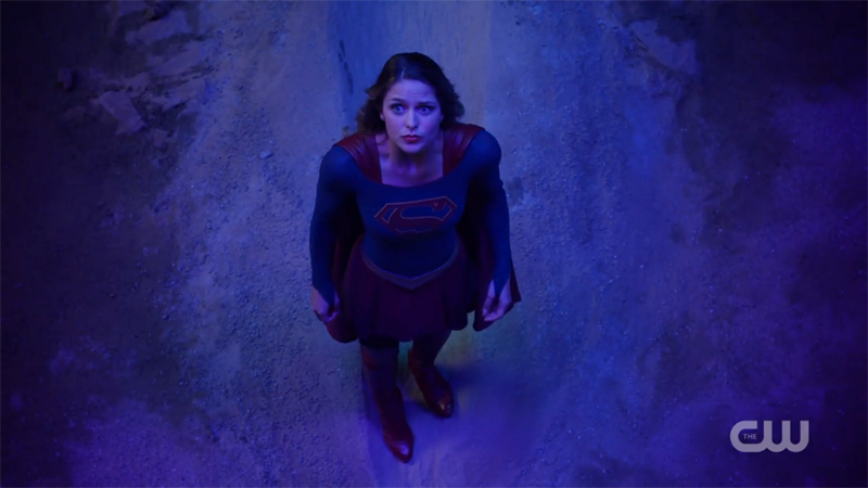 Supergirl looks up at the sky helplessly 