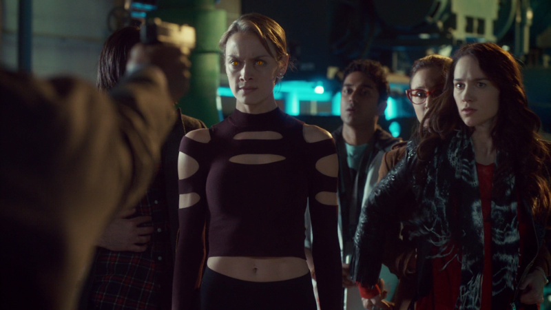 The group stands facing Art's gun; Eliza's eyes glow, Wynonna stands in front of Waverly