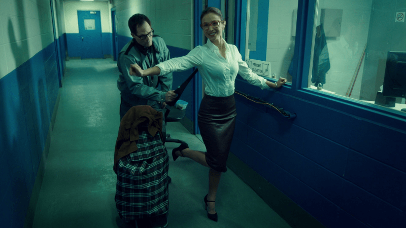 Waverly holds her arms out and pops her heel up in her little british librarian outfit