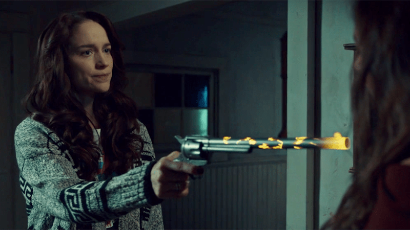 Wynonna points a glowing Peacemaker at Dark Waverly