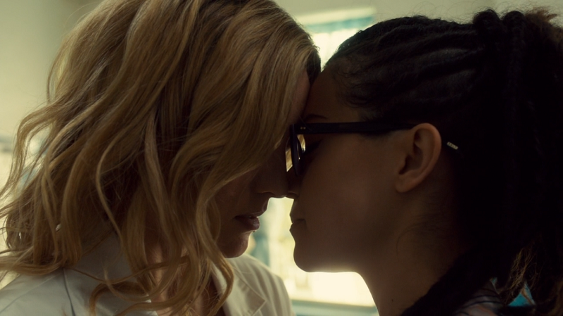 Delphine and Cosima rest their foreheads against each other's