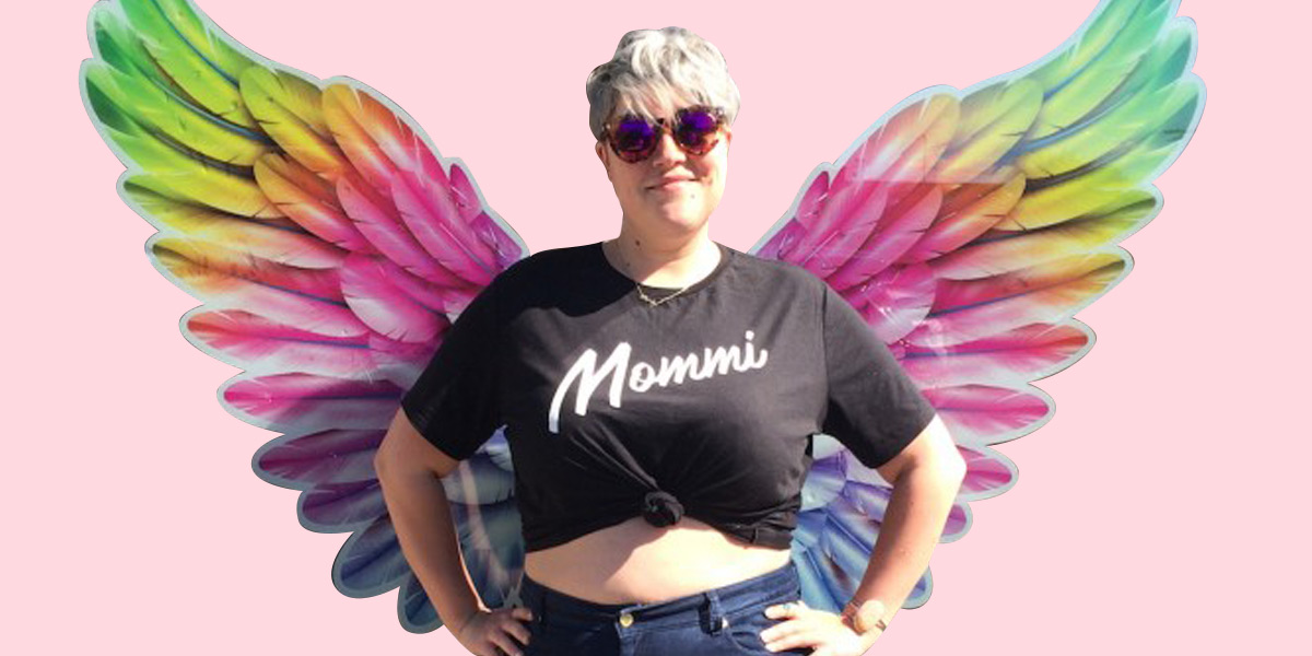 Binky wearing a black Mommi tee with rainbow wings!