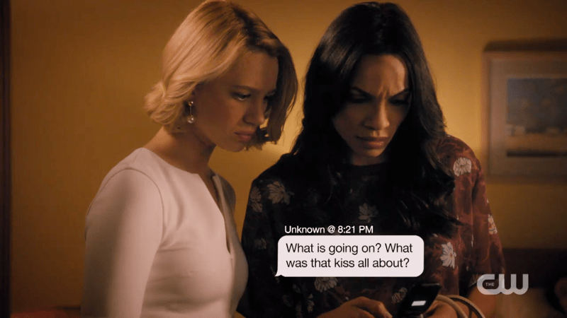 Jane and Petra read a text that says "what is going on? what was that kiss all about?"