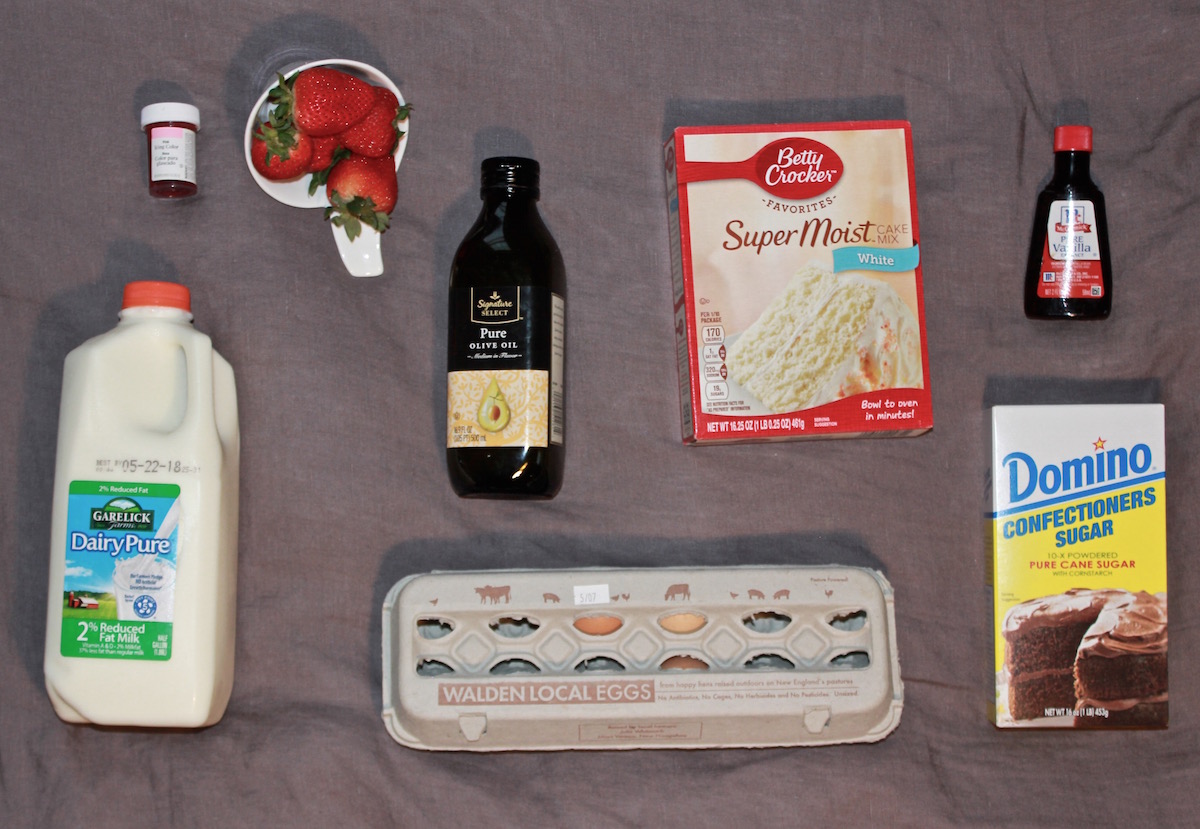 ingredients to make a cake (eggs, strawberries, box cake mix, etc)