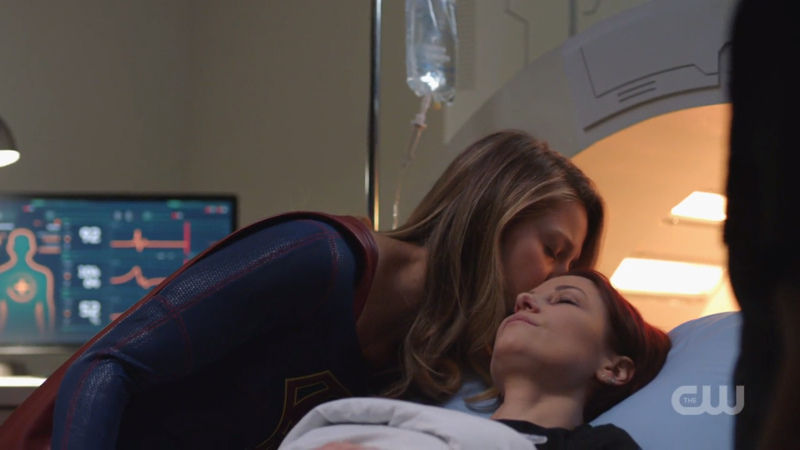 Kara kisses Alex gently on the forehead 