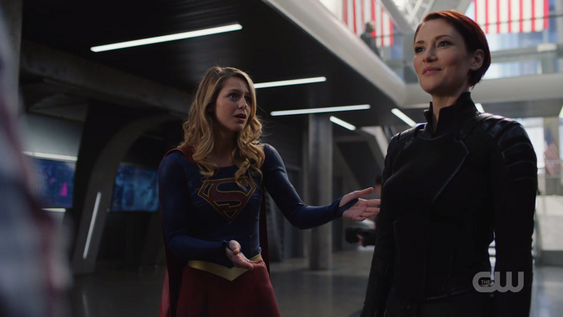 Kara holds her hands out in appreciation of Alex's new suit