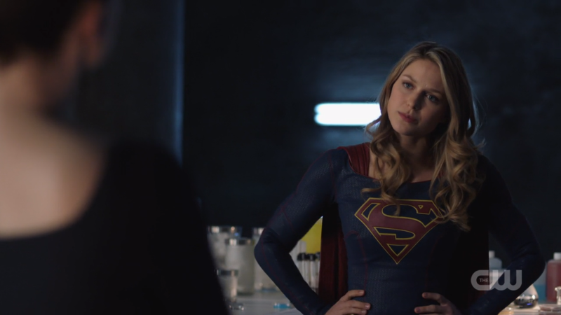 Supergirl stands with her hands on her hip, looking salty