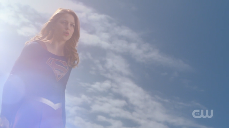 Supergirl flies and quirks an eyebrow at the same time