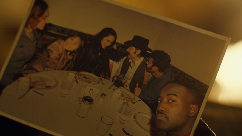 the photograph of the whole gang smiling at a diner