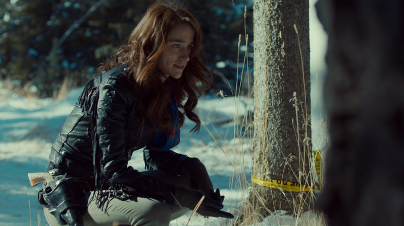 Wynonna crouches down to inspect evidence