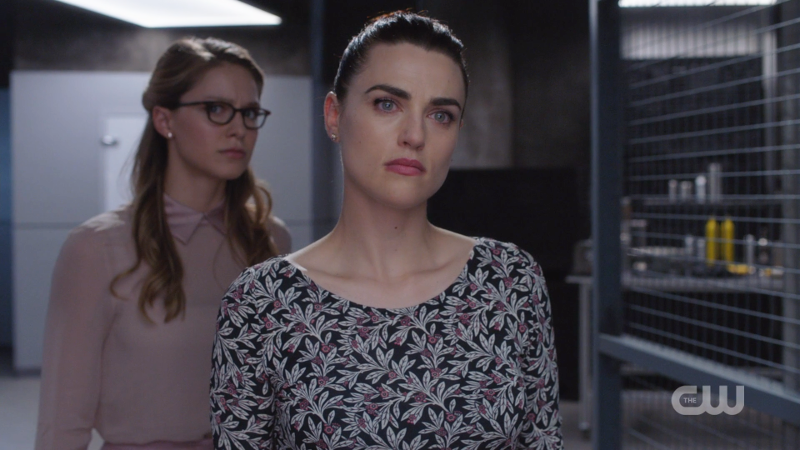 Lena stands in front of a nervous looking Kara