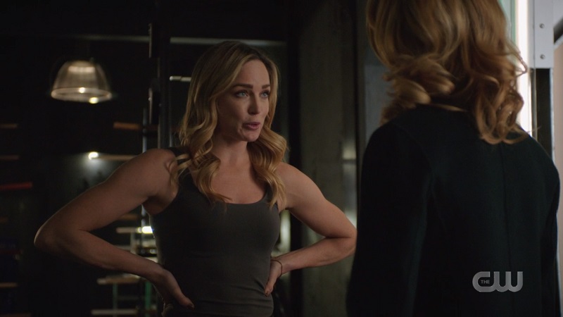 Sara has her hands on her hips and her ARMS are very muscley