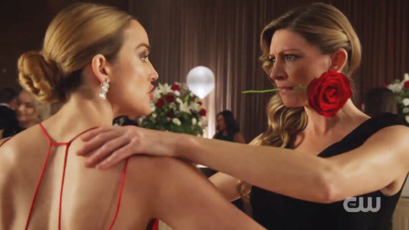 Ava has a rose in her mouth as she dances with Sara