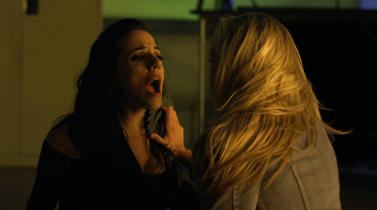 Tamsin holds a circular blade against the neck of Bo on Lost Girl