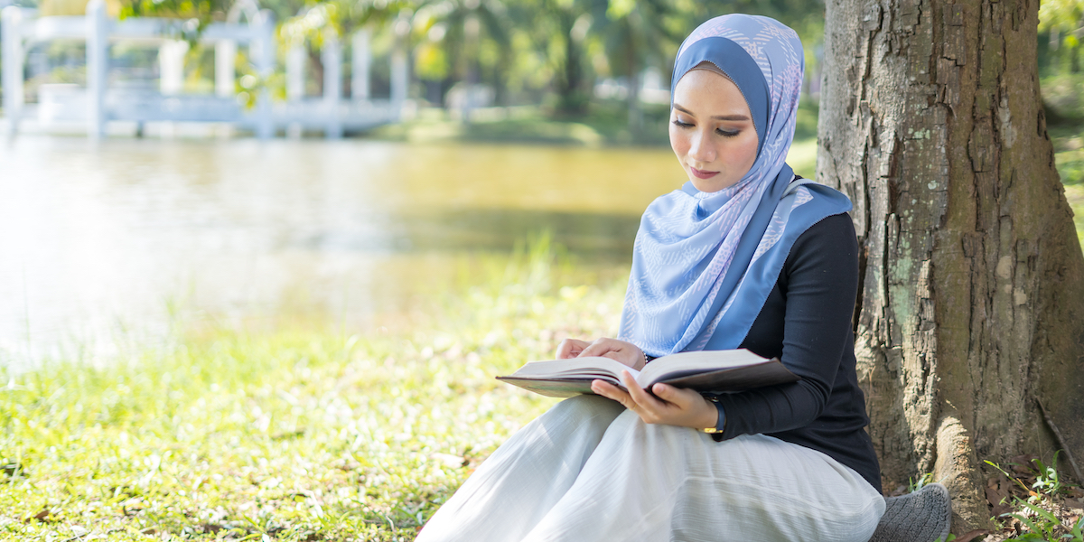 A woman reading a book outside