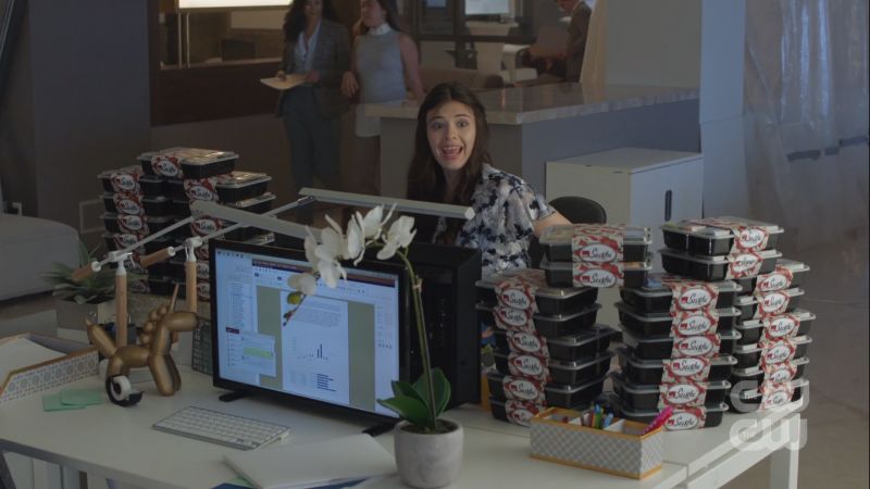 nia smiles over shushi boxes