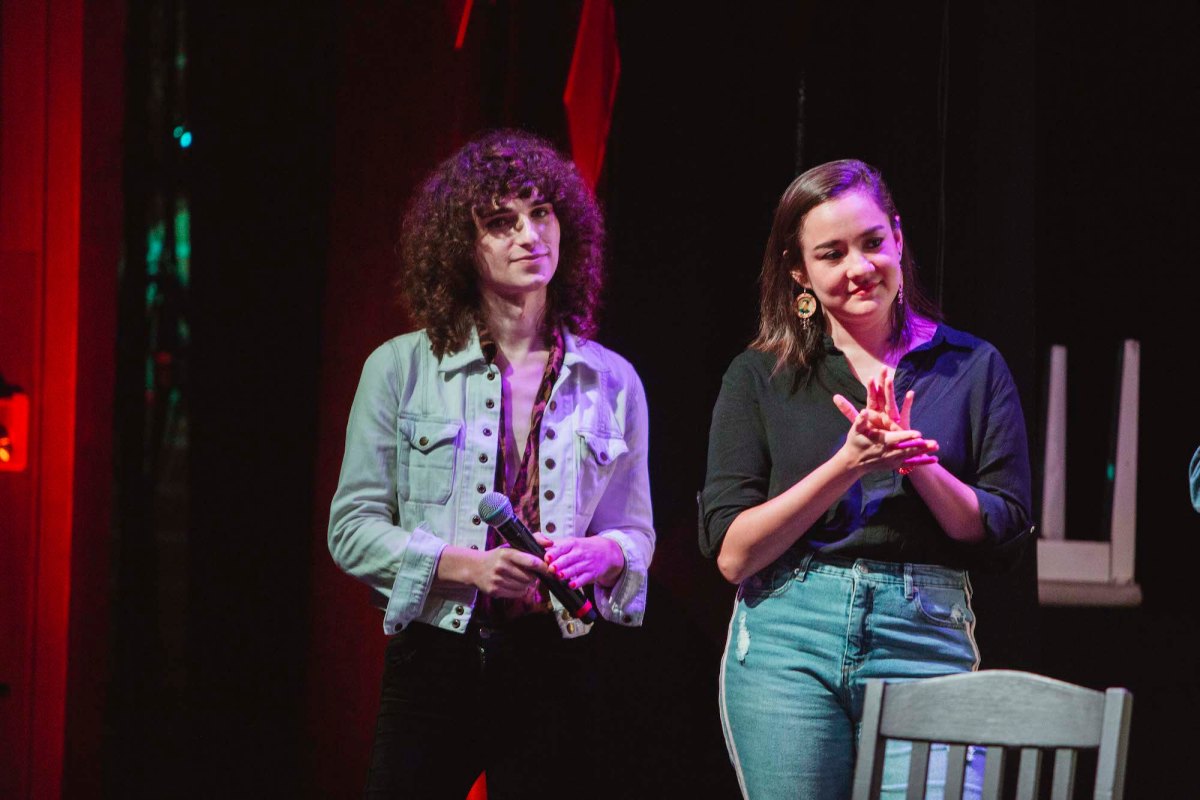 Drew Gregory and Analyssa Lopez stand on stage. 