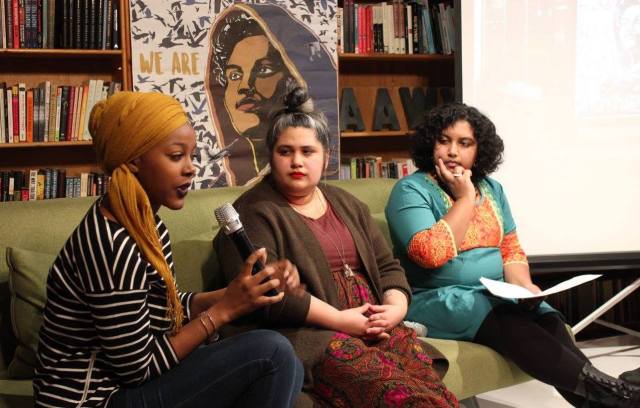 three people, including the authors, sit on a couch on a stage in conversation