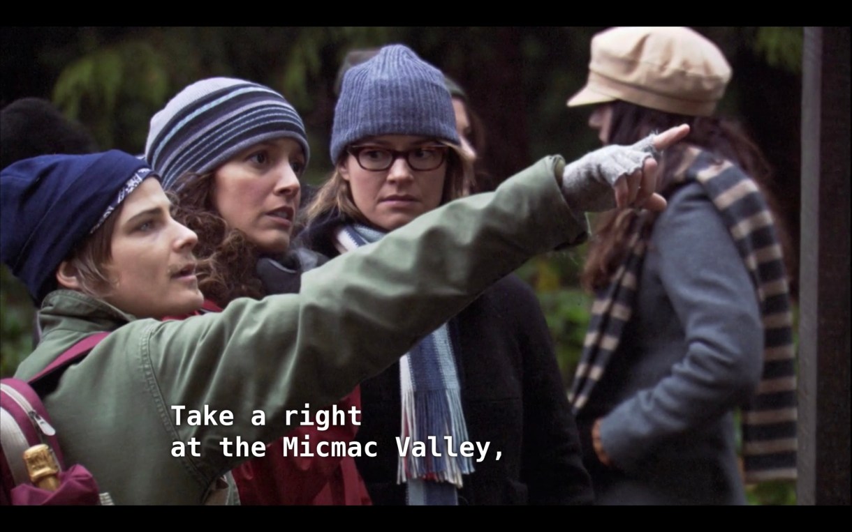 Max, Bette, and Alice are preparing to go on a hike in Dana's memory. Max is pointing out in front of him and says, "Take a right at the Micmac Valley"