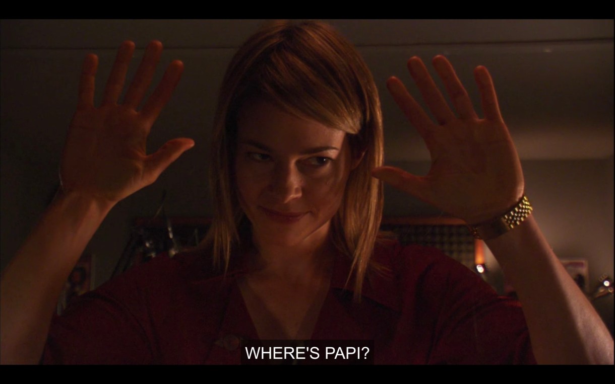 Alice plants her palms on the clear glass wall between her and the editors of her radio show, and says "Where's Papi?"