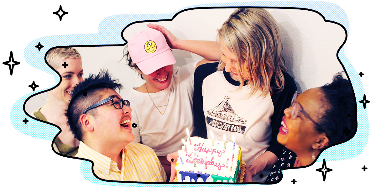 riese holding a cake that says happy birthday, surrounded by sarah, carmen, kamala and laneia laughing