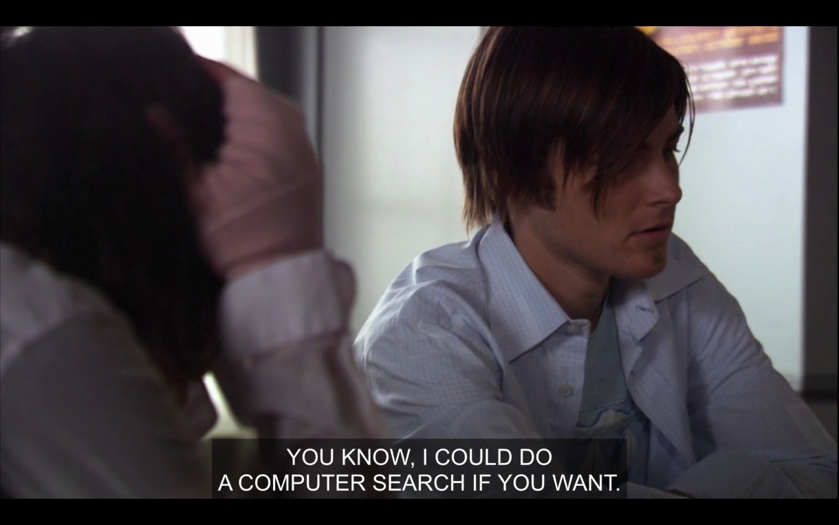 Max, wearing an opened blue button-up, saying, "You know, I could do a computer search if you want."