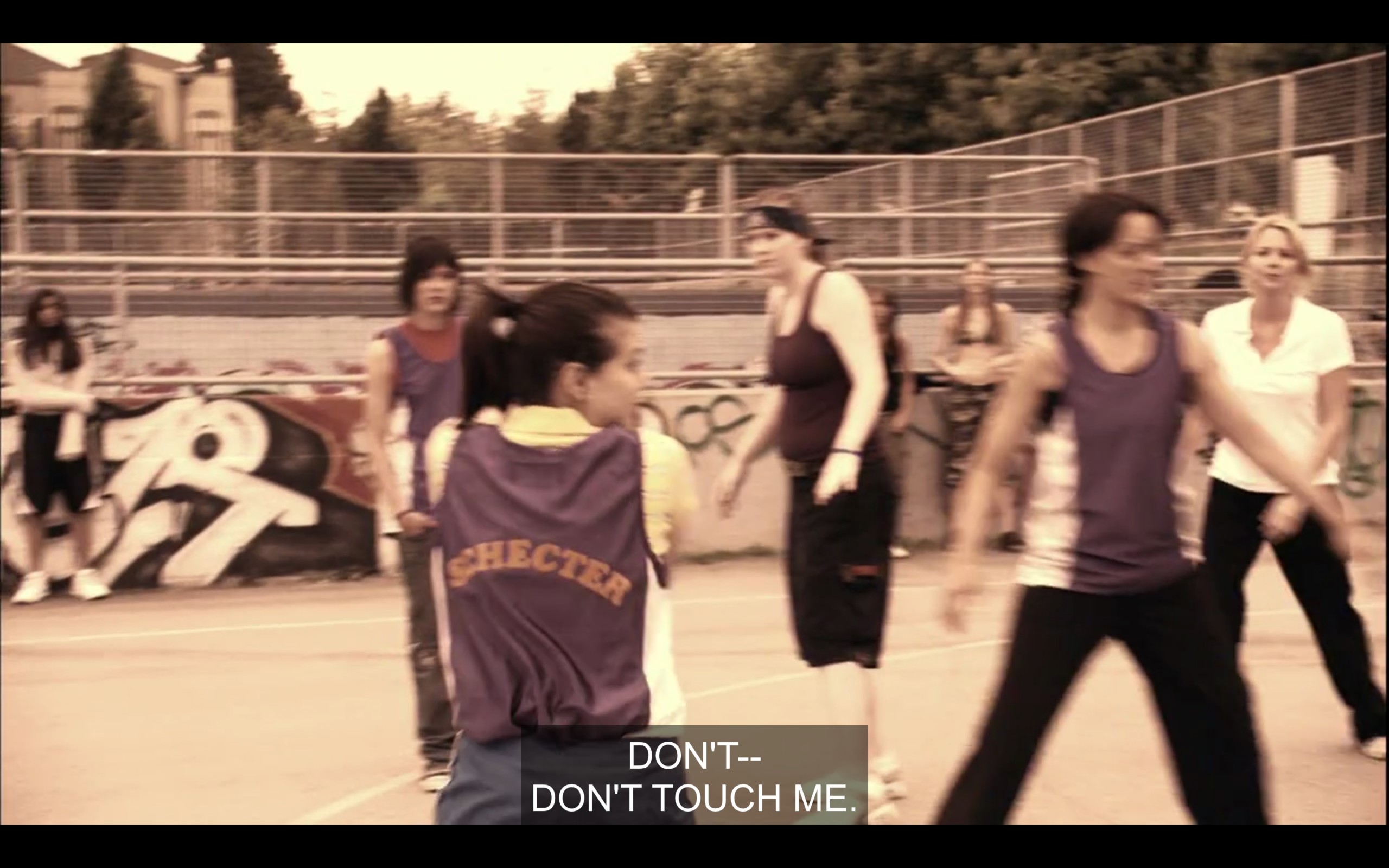 Jenny, Shane, Bette, Tina, and one of their opponents on the basketball court. Jenny has just grabbed the ball and says, "Don't touch me!"