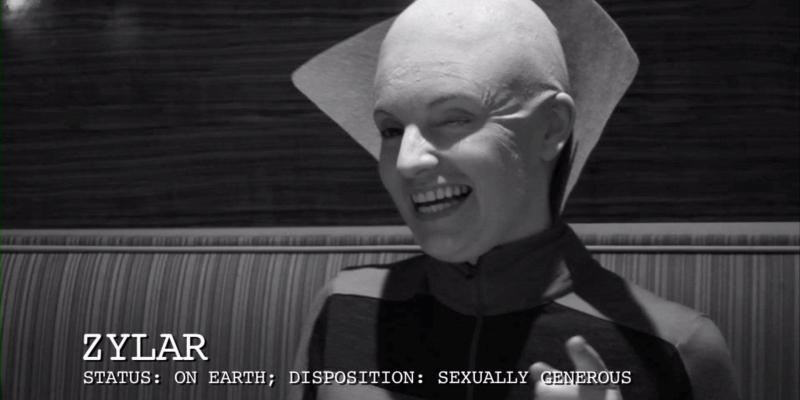 A bald alien winks at the camera. Below the text reads ZYLAR Status: On Earth; Disposition: Sexually generous